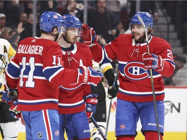 Montreal Canadiens Paul Byron, centre, is congratulated by teammates Brendan Gallagher and Alex Galchenyuk after scoring goal against the Pittsburgh Penguins during first period of National Hockey League game in Montreal, Thursday March 15, 2018.