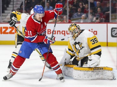Montreal Canadiens Brendan Gallagher deflects puck through his legs at Pittsburgh Penguins goalie Tristan Jarry during third period of National Hockey League game in Montreal, Thursday March 15, 2018.