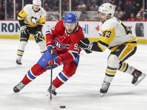 Canadiens' Jonathan Drouin tries to get around Penguins' Conor Sheary Thusday night at the Bell Centre.
