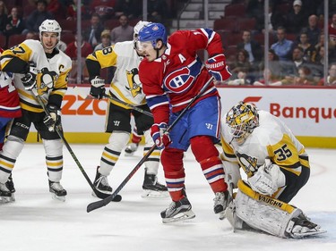 Montreal Canadiens Brendan Gallagher screens Pittsburgh Penguins goalie Tristan Jarry as Sidney Crosby watches play at left during third period of National Hockey League game in Montreal, Thursday March 15, 2018.