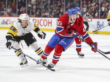 Montreal Canadiens Daniel Carr stickhandles by Pittsburgh Penguins  Carl Hagelin during third period of National Hockey League game in Montreal, Thursday March 15, 2018.