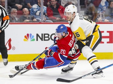 Montreal Canadiens Nicolas Deslauriers is hauled down by Pittsburgh Penguins Jamie Oleksiak during first period of National Hockey League game in Montreal, Thursday March 15, 2018. Oleksiak was penalized on the play.