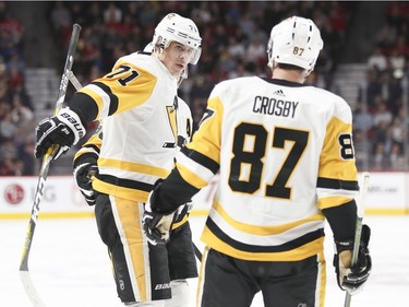 Pittsburgh Penguins Evgeni Malkin celebrates his second period goal with Sidney Crosby during of National Hockey League game against the Canadiens in Montreal, Thursday March 15, 2018.