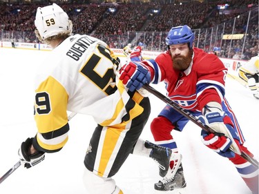 Montreal Canadiens Jamie Benn shoves Pittsburgh Penguins Jake Guentzel during second period of National Hockey League game in Montreal, Thursday March 15, 2018.