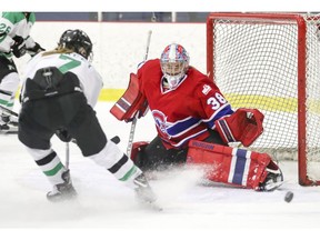 Les Canadiennes de Montréal goalie Emerance Maschmeyer slides across the crease as Markham Thunder's Laura Stacey can't get her stick on the puck during second period of Canadian Women's Hockey League semifinal game in Montreal on March 16, 2018.