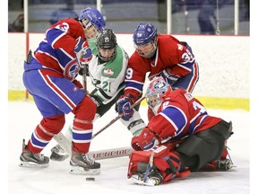 Les Canadiennes' Caroline Ouellette, left, Marion Allmoz and goalie Emerance Maschmeyer and Markham Thunder's Devon Skeats battle for loose puck in front of Montreal's net in a Canadian Women's Hockey League playoff game in Montreal on Friday, March 16, 2018.