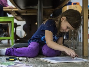 Five-year-old Naomi meticulously places a tile on her mosaic project at Communidée, a St-Henri centre that offers activities and support for people who choose to educate outside the government system. About 80 children from 50 families are members of the centre.