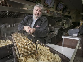 Peter Anoussos prepares the day's first batch of fries at Restaurant A.A. on Notre-Dame St. W. Despite renovations, the place has retained the look and feel of an old-style, no-frills casse-croûte.
