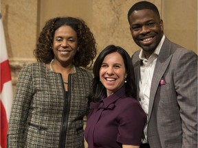 Mayor Valérie Plante, centre, poses with Myrlande Pierre, the chairperson of the advisory committee, and committee member Paul Evra after announcement at city hall on Monday, March 19, 2018.