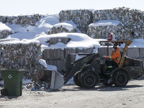 Bales of paper meant to be recycled are stacked outside the St-Michel Environmental Complex in Montreal on March 19, 2018.