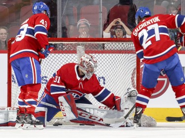 Montreal Canadiens goalie Carey Price takes shots from teammates Daniel Carr, left, and Alex Galchenyuk during warm-up prior to National Hockey League game against the Florida Panthers in Montreal Monday March 19, 2018.