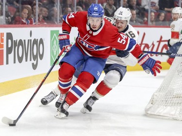 Montreal Canadiens Charles Hudon holds off Florida Panthers Aleksander Barkov during first period of National Hockey League game in Montreal Monday March 19, 2018.