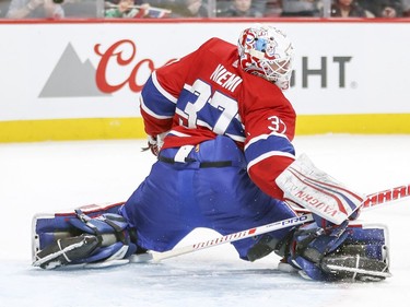 Montreal Canadiens goalie Antti Niemi twists his body to make a save against the Florida Panthers during second period of National Hockey League game in Montreal Monday March 19, 2018.