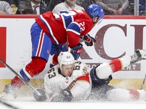 Montreal Canadiens Karl Alzner checks Florida Panthers Evgenii Dadanov during second period of National Hockey League game in Montreal Monday March 19, 2018.