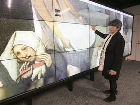 Guylaine Beaudry, Concordia University vice-provost and librarian demonstrates the touch-screen controls for navigating a high-resolution scan of paintings in the Visualization Studio in the upgraded Webster Library. (Pierre Obendrauf / MONTREAL GAZETTE)