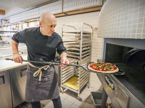 Chef/co-owner Vincent Châtelais fills up Heirloom Pizzeria's wood-burning oven.