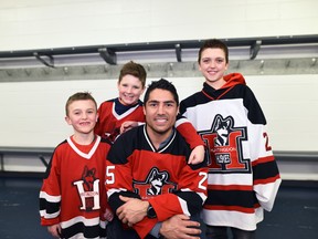 Former Canadiens defenceman Francis Bouillon poses with some children in Huntingdon. The city is one of four finalists for the 2018 Kraft Hockeyville title.