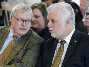 "I have never been in favour of it," Health Minister Gaétan Barrette, pictured with Premier Philippe Couillard, says of the decision to abolish the post of commissioner of health and welfare.