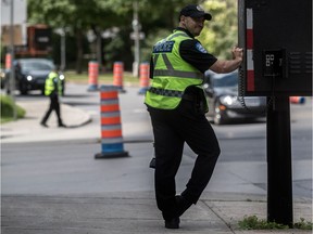 Police officers are trying to help us help ourselves when they issue tickets for jaywalking and the like, says columnist Marc Richardson. Above: Officer Bissonnette mans the corner of Atwater Ave. and René Lévesque Blvd. in June 2017.