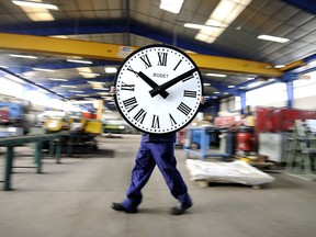 An employee of the Bodet Company springs forward at the clock plant in France.