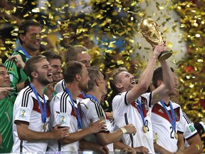 German players celebrate with their trophy after winning the 2014 FIFA World Cup in Rio de Janeiro. "FIFA would pay zero tax in the city of Montreal, the province of Quebec or the nation of Canada on any of the massive profits it will generate" for the 2026 World Cup, Jack Todd writes.