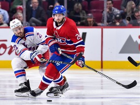 Kevin Shattenkirk (#22) of the N.Y. Rangers challenges Phillip Danault (#24) of the Montreal Canadiens during a NHL game at the Bell Centre on October 28, 2017 in Montreal.