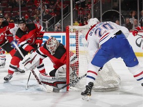 Keith Kinkaid (#1) of the New Jersey Devils stops Nicolas Deslauriers (#20) of the Montreal Canadiens during the third period at the Prudential Center on March 6, 2018 in Newark, New Jersey. The Devils defeated the Canadiens 6-4.
