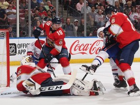 Panthers goaltender Roberto Luongo covers the puck during a scramble in front of the net against the Canadiens at the BB&T Center Thursday night in Sunrise, Fla.
