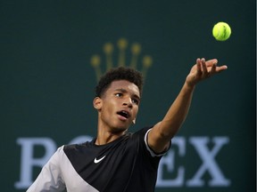 Félix Auger-Aliassime of Montreal prepares to serve to fellow Canadian Milos Raonic during the BNP Paribas Open on March 11, 2018, in Indian Wells, California.
