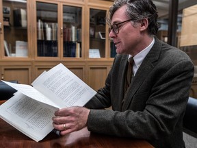Christopher Lyons, head librarian for rare books and special collections at McGill University, came upon a treasure trove of late mayor Jean Drapeau's personal books at an antiquarian book fair that are now on display at the university. Here, Lyons leafs through Drapeau's personal copy of the Malouf report – the conclusions of a three-year public inquiry into the debt-ridden 1976 Montreal Olympics.