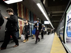 Metro riders make their way on the platform at the Montmorency Metro station in Montreal Tuesday February 27, 2018.