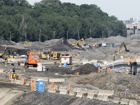 The Falaise St-Jacques forms a backdrop behind the Turcot Interchange reconstruction project in 2016. Transport Quebec says it plans to protect the escarpment with a "bande verte."
