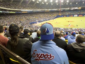 Fans sport Expos gear as they watch the Toronto Blue Jays in a preseason game against the New York Mets on March 28, 2014, in Montreal.