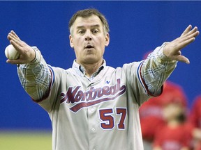 Former Montreal Expo pitcher John Wetteland jokingly asks for room around the plate before throwing out the first pitch before a spring training baseball game between the Toronto Blue Jays and St. Louis Cardinals on Monday, March 26, 2018 in Montreal.