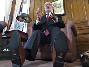 Quebec Finance Minister Carlos Leitao, right, unveiled his new budget shoes as per tradition, but this year there was a twist and a personal delivery by Aldo Shoes CEO Aldo Bensadoun. THE CANADIAN PRESS/Jacques Boissinot