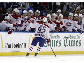 Montreal Canadiens center Jonathan Drouin (92) celebrates with the bench after his shootout goal against the Tampa Bay Lightning during an NHL hockey game Saturday, March 10, 2018, in Tampa, Fla. The Lightning won the game 3-2.