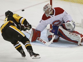Montreal Canadiens goaltender Carey Price (31) stops s penalty shot by Pittsburgh Penguins' Derick Brassard during the first period of an NHL hockey game in Pittsburgh, Wednesday, March 21, 2018.