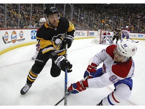 Montreal Canadiens' Jonathan Drouin (92) knocks the puck off the stick of Pittsburgh Penguins' Bryan Rust (17) during the second period of an NHL hockey game in Pittsburgh, Saturday, March 31, 2018.
