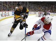 Montreal Canadiens' Jonathan Drouin (92) knocks the puck off the stick of Pittsburgh Penguins' Bryan Rust (17) during the second period of an NHL hockey game in Pittsburgh, Saturday, March 31, 2018.