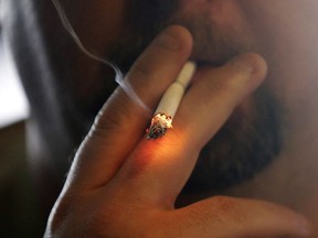 A man smokes a cigarette in New Orleans.