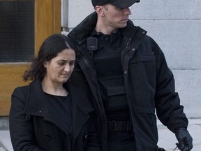 Tooba Yahya is led away from the Frontenac County courthouse in Kingston, Ont., Sunday, January 29, 2012, after being found guilty of first degree murder. A woman found guilty in 2012 of murdering her three daughters in a so-called mass honour killing has been stripped or her permanent residency and ordered deported from Canada.THE CANADIAN PRESS/Graham Hughes