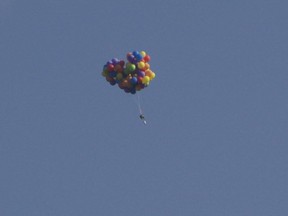 Daniel Boria said he and his assistants filled 120 balloons — each about six feet in diameter — with helium and when the chair was released, he shot up into the air at just over 150 metres a minute.