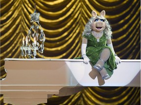 This image released by Disney shows muppet characters Rowlf, left, and Miss Piggy in a scene from "Muppets Most Wanted." Miss Piggy is holding court in Toronto Tuesday to promote the film in which she sings a song with Celine Dion.THE CANADIAN PRESS/AP/Disney, Jay Maidment ORG XMIT: CPT106