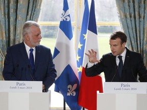 Quebec Premier Philippe Couillard, left, and French President Emmanuel Macron hold a press conference following their meeting at the Elysee Palace in Paris, France, March 5, 2018. (Gonzalo Fuentes/Pool Photo via AP)
