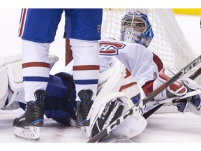 Canadiens goaltender Charlie Lindgren looks up at one of his defencemen during the second period of his team's 4-0 loss to the Maple Leafs in NHL hockey action in Toronto on Saturday, March 17, 2018.