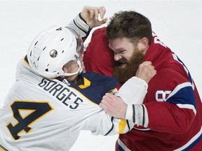 Montreal Canadiens' Jordie Benn and Buffalo Sabres' Josh Gorges fight in Montreal, on November 11, 2017.