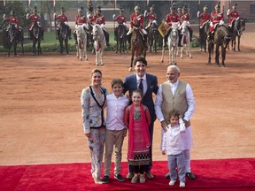 Indian Prime Minister Narendra Modi, right, poses for the photographers with his Canadian counterpart Justin Trudeau and his family, wife Sophie Gregoire Trudeau, left, sons Xavier and Hadrien, daughter Ella-Grace upon their arrival at the Indian presidential palace during a ceremonial reception, in New Delhi, on Feb. 23, 2018.