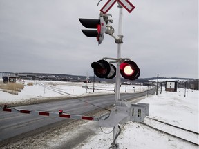 A rail level crossing in Quebec during winter.
