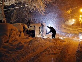 Residents dig out their car after a snowstorm in the New Jersey area on Wednesday, March 7, 2018. The storm carrying wind, rain and heavy snow was expected to continue into Wednesday night.