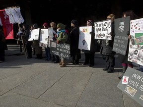 A commemoration ceremony for victims of the Polytechnique massacre is held outside the Montreal courthouse in December 2013.